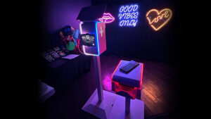 custom neon sign backdrop with our white venture photo booth in florida